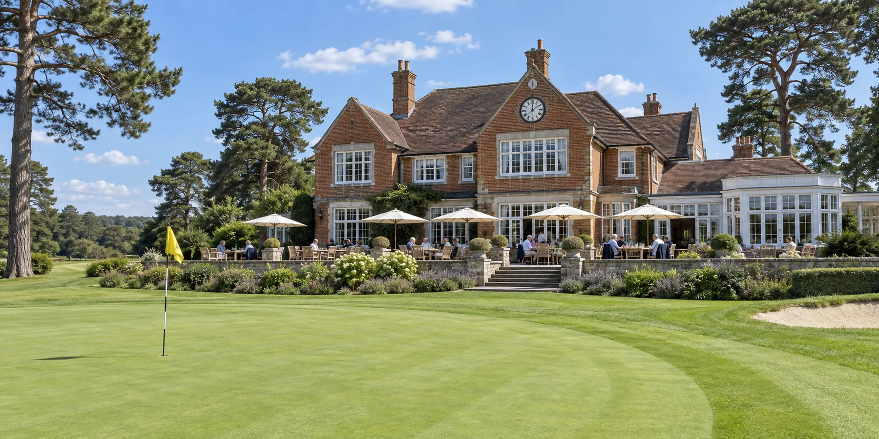 The Edwardian clubhouse at Wrenmoor Heath, members at lunch on the terrace above the 18th green.